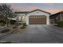 Single-story home with a two-car garage and desert landscaping at 2156 W Sierra Sunset Trl, Phoenix, AZ 85085