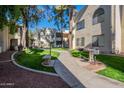 Well-maintained courtyard with a walking path, grass, and trees at 750 E Northern Ave # 1053, Phoenix, AZ 85020