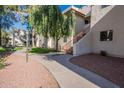 Paved pathway winds through a grassy courtyard with trees and lamp posts at 750 E Northern Ave # 1053, Phoenix, AZ 85020