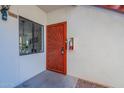 Condo entrance with a red security door and a window at 750 E Northern Ave # 1053, Phoenix, AZ 85020