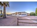 Front view of a single story home with palm trees at 816 S Esperanza Ave, Mesa, AZ 85208