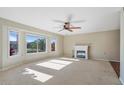 Bright living room featuring a fireplace and large windows at 886 Leisure World --, Mesa, AZ 85206