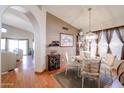 Charming dining room with a glass-top table and hardwood floors at 9818 W Mohawk Ln, Peoria, AZ 85382