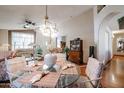 Elegant dining room with a glass-top table and hardwood floors at 9818 W Mohawk Ln, Peoria, AZ 85382