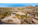 Aerial view showcasing a beautiful home with solar panels and a mountain backdrop at 10400 E Breathless Ave, Gold Canyon, AZ 85118