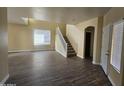 Spacious living room with hardwood floors and staircase at 11410 W Cocopah St, Avondale, AZ 85323