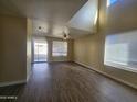 Living room with hardwood floors, access to backyard, and high ceiling at 11410 W Cocopah St, Avondale, AZ 85323