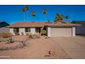 Single-story home with a two-car garage and desert landscaping at 1348 E Chilton Dr, Tempe, AZ 85283