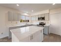 Modern kitchen with gray cabinets and a large kitchen island at 1348 E Chilton Dr, Tempe, AZ 85283