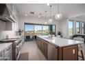 Modern kitchen with island, stainless steel appliances, and mountain views at 14840 E Valley Vista Dr, Fountain Hills, AZ 85268