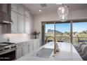 Modern kitchen with a large island, white cabinets, and mountain views at 14840 E Valley Vista Dr, Fountain Hills, AZ 85268