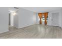 Bright living room featuring light gray walls and wood-look flooring at 17242 N 16Th Dr # 9, Phoenix, AZ 85023