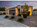 One-story home with gray garage door, landscaping, and a welcoming front porch at 18280 N Piccolo Dr, Maricopa, AZ 85138