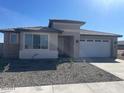 New construction home with neutral tones, two-car garage, and desert landscaping at 19009 W Maryland Ave, Waddell, AZ 85355