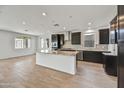 Spacious kitchen with dark cabinetry, granite countertops, and an island at 19339 W Valle Vista Way, Litchfield Park, AZ 85340