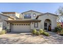 Two-story home with Spanish-style architecture, two-car garage, and landscaped front yard at 20802 N Grayhawk Dr # 1173, Scottsdale, AZ 85255