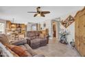 Living room with brown leather couches and a view of a kitchen at 2340 W Myrtle Dr, Chandler, AZ 85248