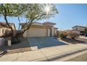 House exterior showcasing a tan facade and a driveway at 25875 W St Catherine Ave, Buckeye, AZ 85326