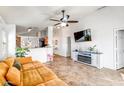 Living room features a flat-screen TV and a modern fireplace at 25875 W St Catherine Ave, Buckeye, AZ 85326