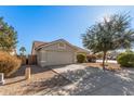 House exterior showcasing a two-car garage and front yard at 2605 S 80Th Ave, Phoenix, AZ 85043