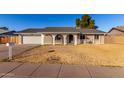 Brick house with a two-car garage and a well-maintained lawn at 2618 W Surrey Ave, Phoenix, AZ 85029