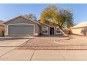 Single-story house with a two-car garage and desert landscaping at 2818 N 90Th Ave, Phoenix, AZ 85037