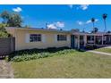 Tan colored house with a covered patio and lush landscaping at 303 W 9Th St, Mesa, AZ 85201