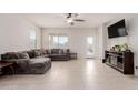 Spacious living room with L-shaped sectional sofa and tile floors at 30905 W Fairmount Ave, Buckeye, AZ 85396