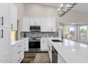 Bright kitchen featuring white cabinets, quartz countertops, and stainless steel appliances at 3101 W Topeka Dr, Phoenix, AZ 85027