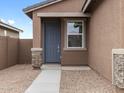 Inviting front entrance with a gray door, stone accents, and manicured desert landscaping at 3201 E Hayden Rose Ave, San Tan Valley, AZ 85143