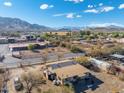 Aerial view of a house with mountain views in the background, highlighting the property's landscape at 3204 W Mcneil St, Laveen, AZ 85339