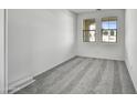 Bright bedroom with new carpeting and large windows at 37535 W Patterson St, Maricopa, AZ 85138