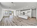 Open concept kitchen with island and stainless steel appliances at 37535 W Patterson St, Maricopa, AZ 85138