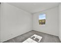 Bright bedroom with carpet flooring and a large window at 37536 W Patterson St, Maricopa, AZ 85138