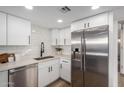 Sleek kitchen with stainless steel appliances and white cabinetry at 4411 N 40Th St # 52, Phoenix, AZ 85018