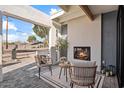 Outdoor patio area with a fireplace and seating, overlooking the street at 4437 N Granite Reef Rd, Scottsdale, AZ 85251