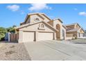 Charming two-story home with a three-car garage, arched entryway, and desert-friendly landscaping at 4968 E Grandview Rd, Scottsdale, AZ 85254