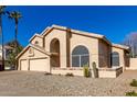 Two-story house with three-car garage and mature desert landscaping at 4968 E Grandview Rd, Scottsdale, AZ 85254