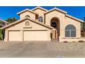 Two-story house with three-car garage and desert landscaping at 4968 E Grandview Rd, Scottsdale, AZ 85254