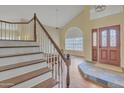 Staircase leading upstairs with wood treads, white risers, and a decorative wood banister at 4968 E Grandview Rd, Scottsdale, AZ 85254