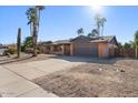 Ranch-style home with a two-car garage and mature palm trees at 5109 E Blanche Dr, Scottsdale, AZ 85254