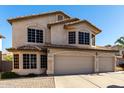 Two-story house with three-car garage and landscaped front yard at 553 S Meadows Dr, Chandler, AZ 85224