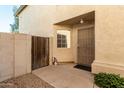 Side entrance with wrought iron door and wooden gate at 553 S Meadows Dr, Chandler, AZ 85224