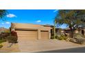 Two-car garage and desert landscaping with mountain views at 6358 E Evening Glow Dr, Scottsdale, AZ 85266