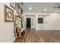 Living room with hardwood floors and decorative wall art at 6414 W Villa Linda Dr, Glendale, AZ 85310