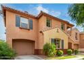 Tan two-story house with a large garage and palm trees at 7827 W Cypress St, Phoenix, AZ 85035