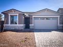 Charming single-story home featuring stone accents, neutral paint, manicured landscaping, and a spacious two-car garage at 8333 N 54Th Ln, Glendale, AZ 85302