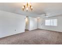 Spacious living room with neutral wall colors and carpet at 10863 W Thunderbird Blvd, Sun City, AZ 85351