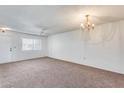 Bright living room featuring carpet and ceiling fan at 10863 W Thunderbird Blvd, Sun City, AZ 85351
