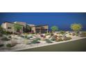 Landscaped desert home boasts a two-car garage with modern curb appeal and native plants at 11972 E Yearling Rd # 20, Scottsdale, AZ 85255